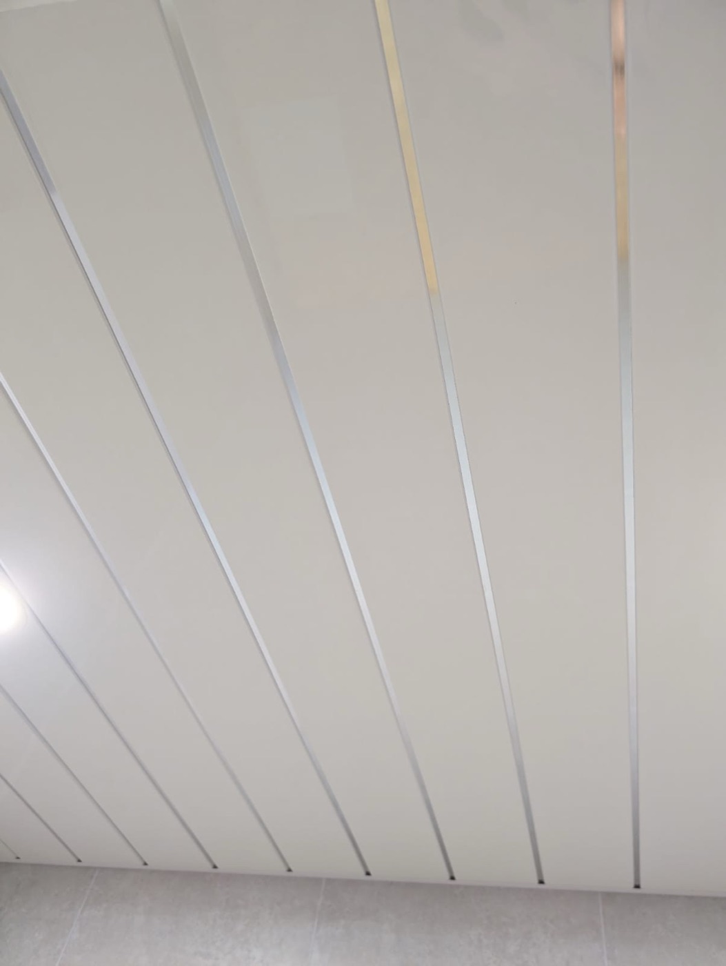 White gloss ceiling panels with chrome strips