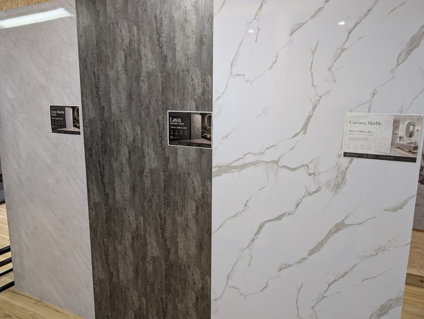 Large-format panels in grey marble, lava metallic and Carrara marble finishes